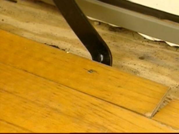 use pry bar to remove damaged pieces of flooring use pry bar to remove damaged pieces of flooring