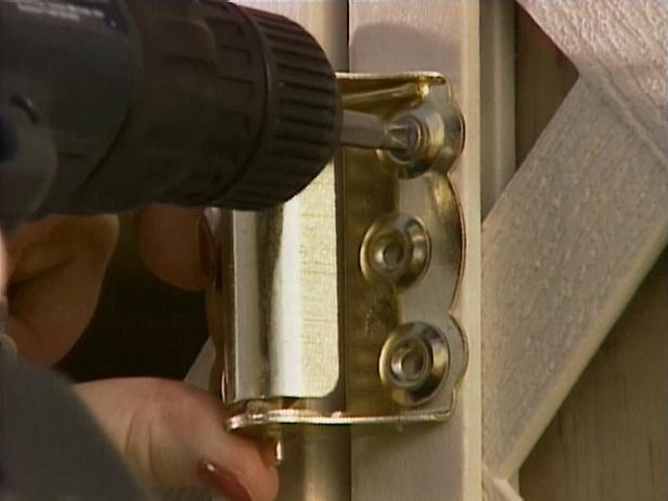 With a power drill, attach the hinges to the door support to secure the door.