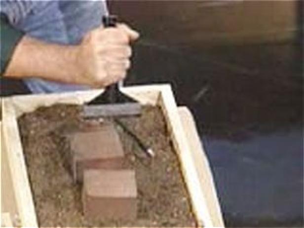 score brick with chisel and tap to break in two score brick with chisel and tap to break in two