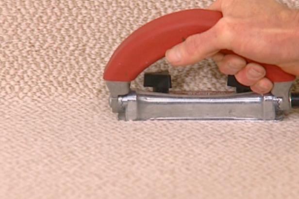 trimmer trims excess carpet against baseboard trimmer trims excess carpet against baseboard