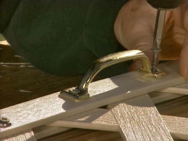 Use a drill to attach a handle to the outside door for easy under-the-deck access.