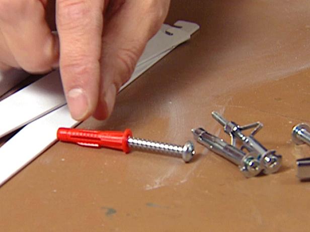 When installing wall anchors, drill a hole into the drywall and then insert the anchor, which expands to hold the screw securely. There are plastic versions and also metal ones for thicker walls.