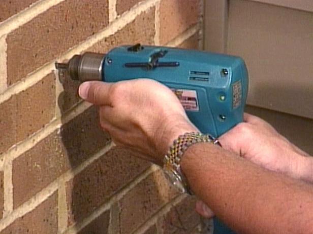 If you plan to attach the transformer to a brick wall, drill mounting holes, using a masonry bit, and place plastic or lead anchors in the holes.