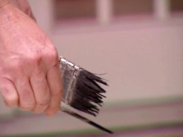 flick bristles of brush to splatter black paint flick bristles of brush to splatter black paint