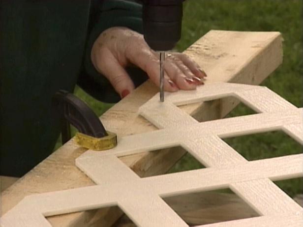 Set the panel and molding in place, then drill pilot holes through the molding and secure the lattice with screws.
