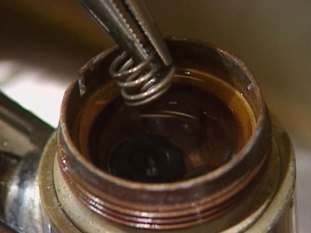 remove spring with pliers and clean out sediment remove spring with pliers and clean out sediment