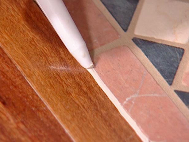 run small bead of caulk between wood and tile run small bead of caulk between wood and tile