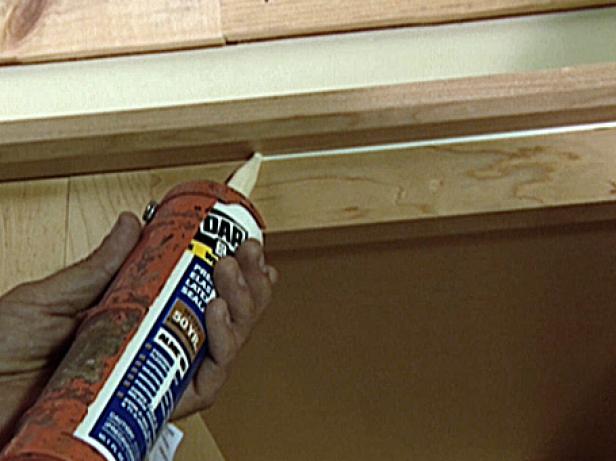 Once the molding is done, a bead of light-colored caulk is applied in the groove between the upper cabinet and molding to conceal the seam (Image 1).