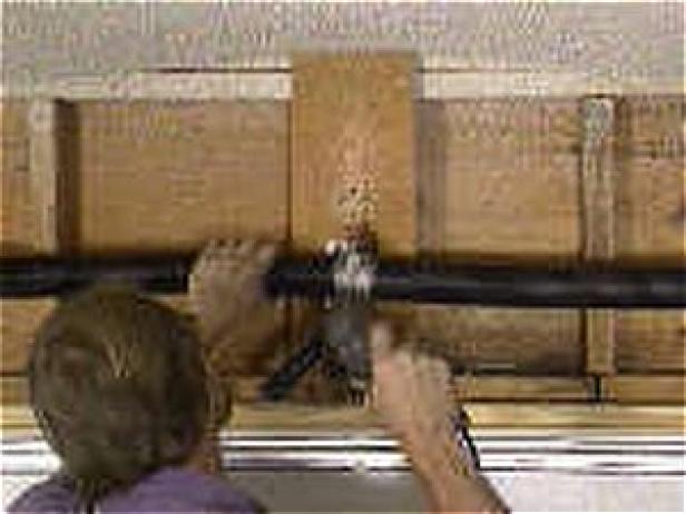 Secure the center header bracket to the center mark on the header (Image 2). You'll probably need to lift the center of the assembly to get it level before attaching it.