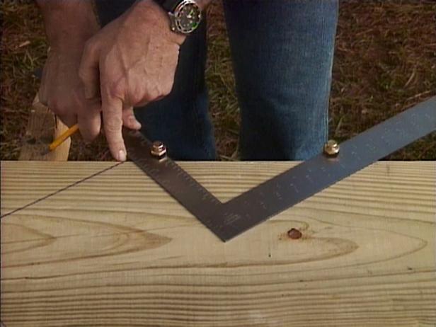 The sides of the stairs, or stringers, are cut from 2x12 boards. Using a framing square, mark out the portions to be cut away from the stringer. Starting at the top corner of the board, place the square so that one leg is 7.46" (the rise) and the other is at 10” (the tread).