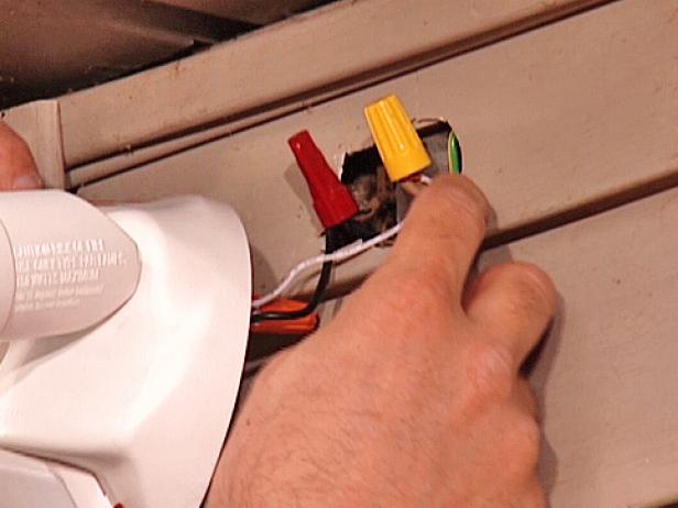 Strip about 3/4” of insulation from the ends of the new fixture wires and twist them onto the wires extending from the wall junction box (black to black wires, white to white wires). Secure each splice with wire nuts.