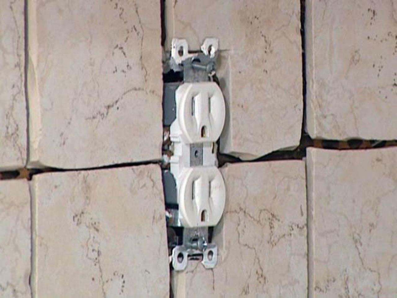 How do you design tile backsplashes around outlets?