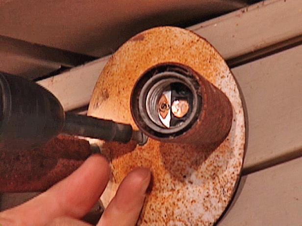 Shut off the power to the light circuit at the main electrical box. Use a drill/driver to remove the mounting screws holding the fixture in place, then remove the fixture