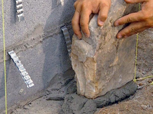 apply mortar to footer and begin setting stone apply mortar to footer and begin setting stone