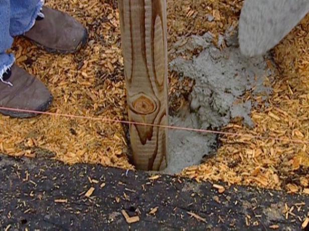 pour cement into post holes to set pour cement into post holes to set