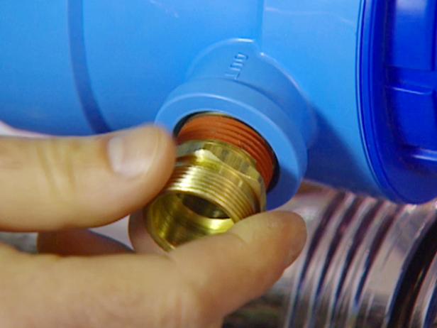 Thread a brass fitting onto the "in" and the "out" ports of the filter housing. Install them according to the manufacturer's recommendations.