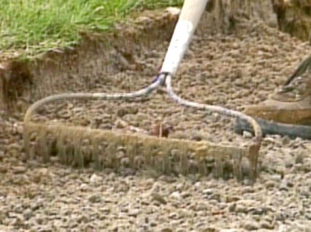 use a rake to smooth the surface of gravel use a rake to smooth the surface of gravel