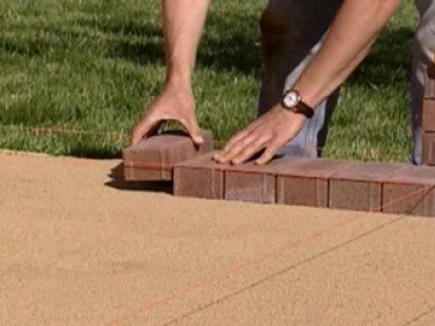 start laying pavers at one corner and press down start laying pavers at one corner and press down