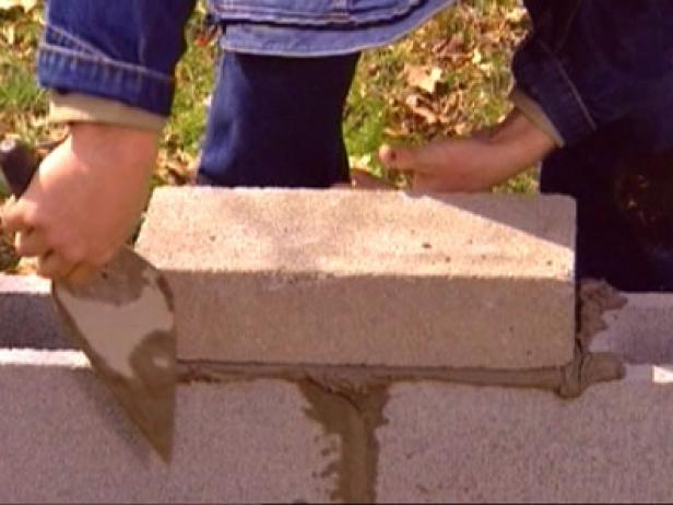 use trowel edge to cut mortar from wall face use trowel edge to cut mortar from wall face