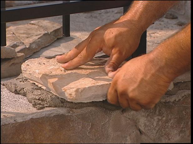 begin laying stones on top of wall cap blocks begin laying stones on top of wall cap blocks