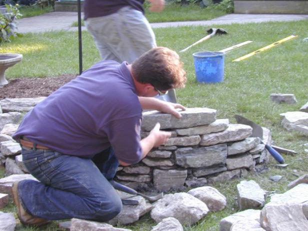 row after row firepit is built to height of wall row after row firepit is built to height of wall