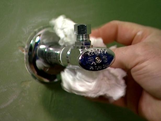 Using two adjustable wrenches, remove the old supply stops from the hot and cold water lines, and then remove the old escutcheon covers.