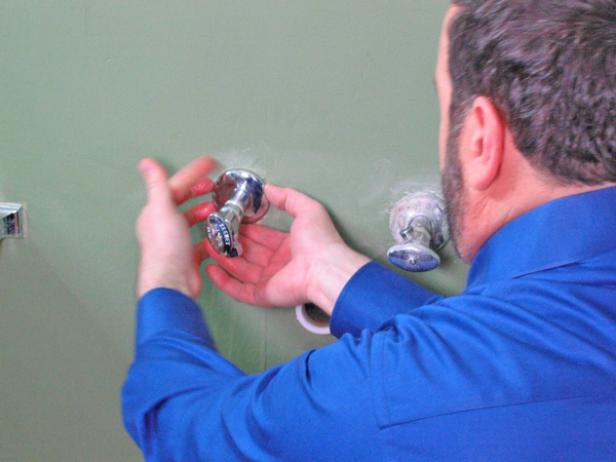 Apply Teflon tape on both stub outs, and then add new escutcheon covers by sliding the cover over the roughed in water supply. Thread new supply stops on both and use a wrench to tighten everything up. Ensure that the inlet valve is in the upright position.