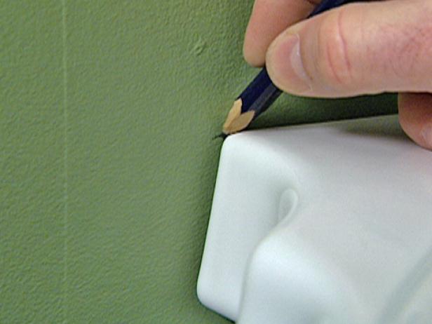 Be sure to center the pedestal to the drain hole on the wall. Once the pedestal is centered, use a pencil to mark where the sink will sit against the wall