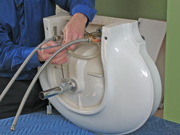Use Teflon tape around the threads of the tailpiece to prevent the drain assembly from leaking. Screw the tailpiece to the drain body. Attach the connecting rod to the drain body, and then connect the stopper rod from the back of the faucet to complete the drain assembly.