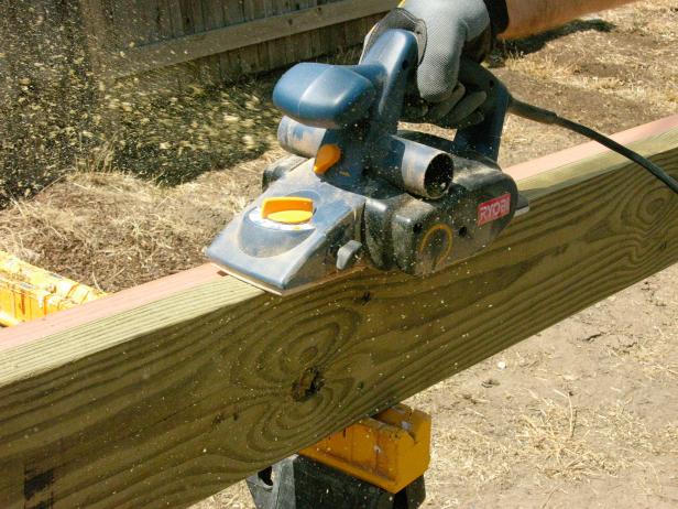 Using pressure-treated lumber, make both boards flush using an electric planer.