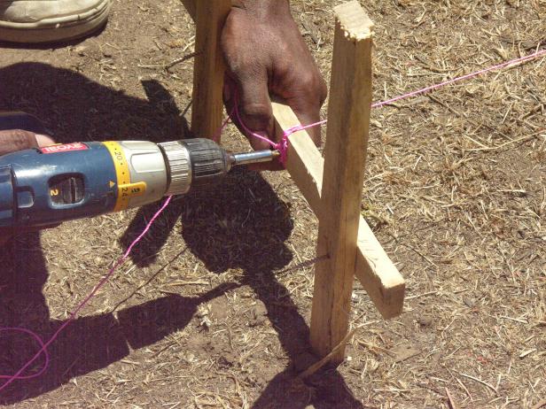 After measuring the dimensions of the yard, center the placement of the deck using strings tied to wood stakes.