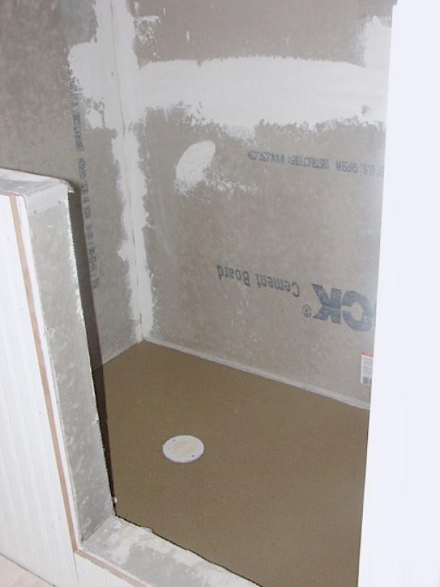 Have a professional install a shower membrane and shower pan appropriate for the space. Here, the shower pan is poured concrete (Image 2).