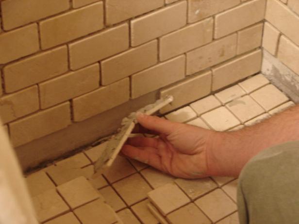 Finish setting the tiles on all sides of the shower with thinset (Image 1).