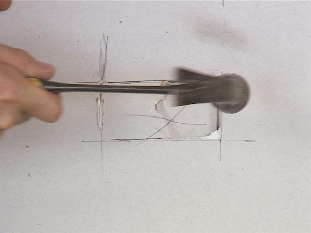 A quick way to get those holes cut is to score the drywall with a utility knife and then simply knock the opening out with a hammer.