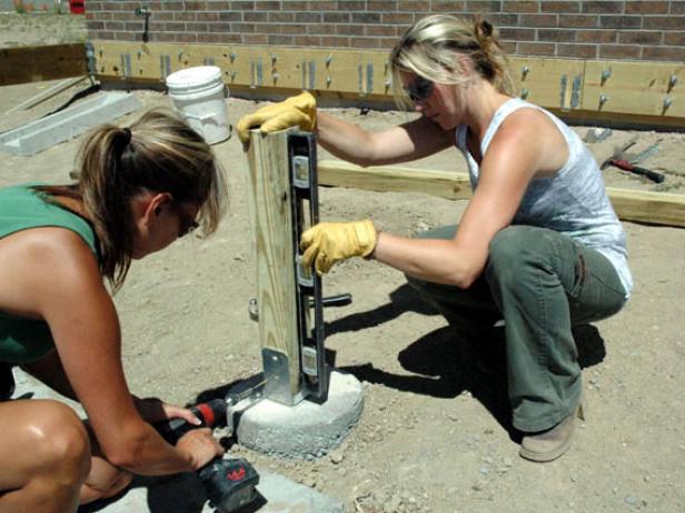 Attach post anchors to the concrete caissons. Attach 4x4 posts to the anchors (Image 2).