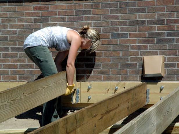 Seat the joists into the hangers and fasten with nails (Image 3).