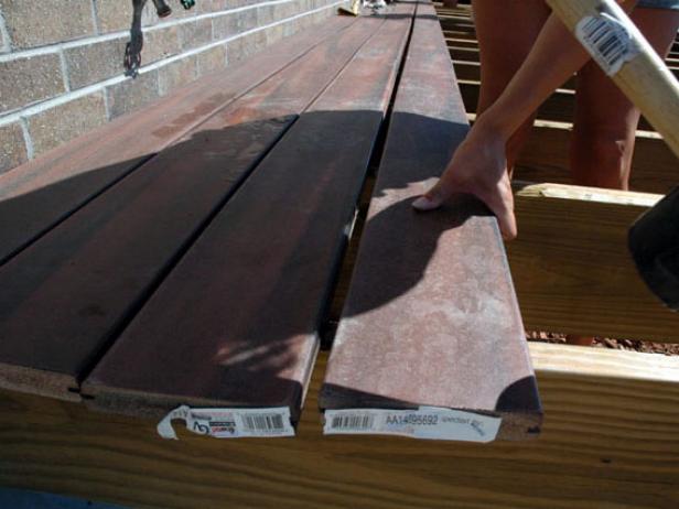 Tap the planks into place with a rubber mallet (Image 4) and then fasten. Stagger the boards as you work.