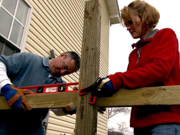 wood and clamps hold posts level as concrete sets wood and clamps hold posts level as concrete sets