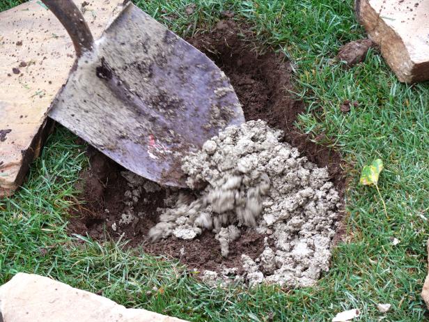 Thinner flagstones will require a layer of crusher run one to three inches deep to ensure stability and create a firm base for the flagstones. Thicker stones do not generally require a base to sit on. Here, we see a layer of crusher run being poured to add stability.