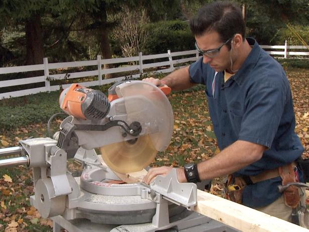 Contractor uses a saw to cut the wooden wall plates in this home repair project.