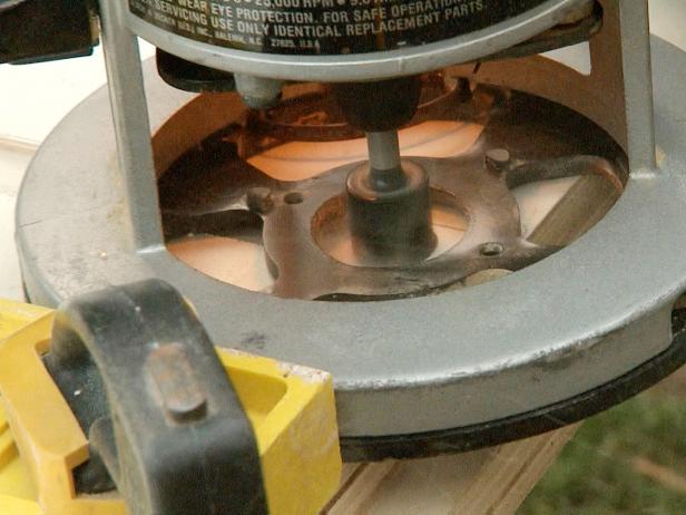 Close up of a tool being used to make rabbit grooves into the wood in this bookcase construction project.