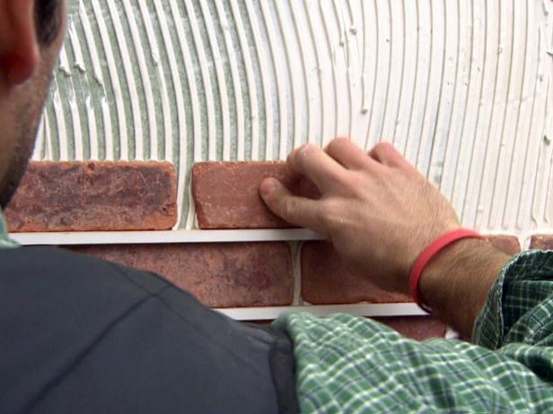 Contractor uses wall grout spaces when installing a brick veneer on the wall.