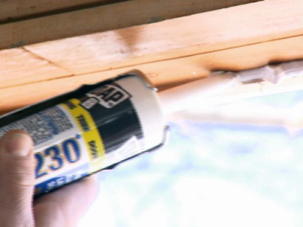 Adding silicone to window edge.