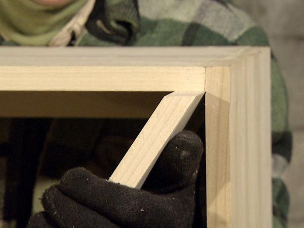 Close up of an angled shelf on a wine rack that is being constructed.