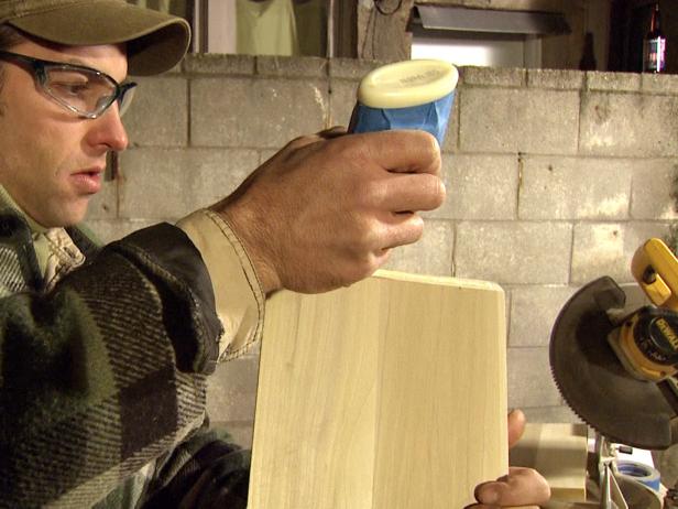 Host uses wood glue to install diagonals into the wine rack frame.