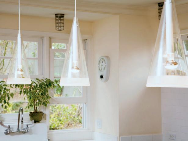 Clear Conical Pendants Hang in a White Kitchen Clear Conical Pendants Hang in a White Kitchen