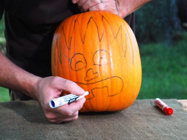 Draw the face. Go for a shocked expression with big open eyes, a button nose and a gapping mouth with big teeth.