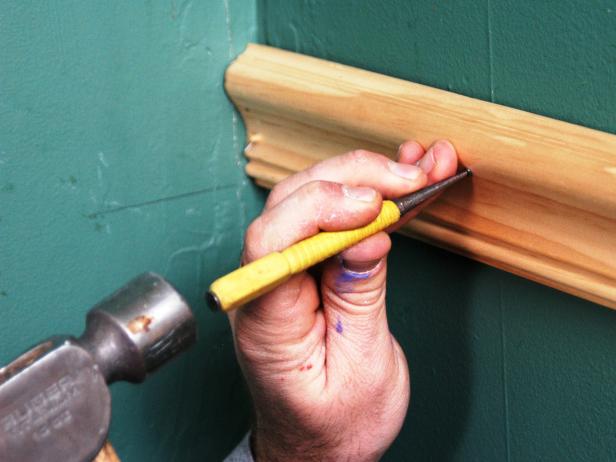 When all of the chair rail molding has been installed, use a hammer and nail set to recess the nail heads, then patch the nail holes with wood filler.