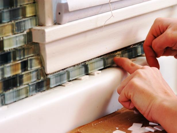 If you are tiling a small area where you can't fit the trowel into, apply the adhesive directly to the back of the tile — known as "back buttering.