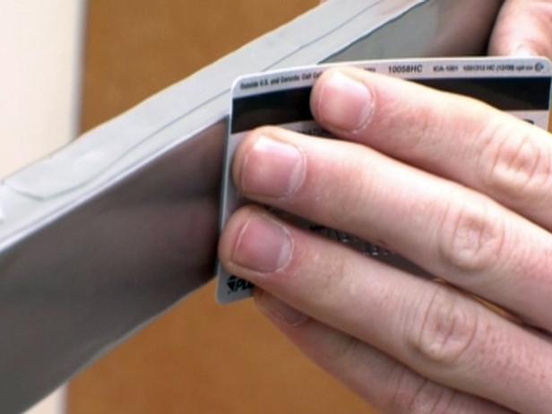 Smoothing edge of material with a flat credit card.